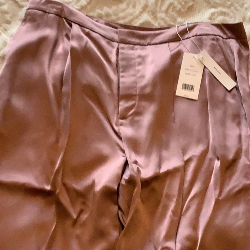It’s a 100% viscose from brand Vince.  It’s light pink.  It’s brand New.